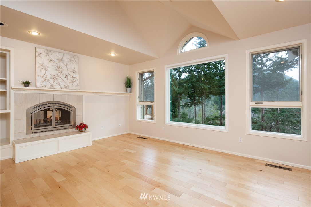 208 Sea Pines Road Bellingham, WA 98229 - Photo 14 of 34 a view of an empty room with a fireplace and a window
