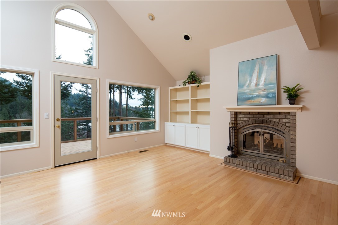 208 Sea Pines Road Bellingham, WA 98229 - Photo 17 of 34 a view of an empty room with a fireplace and a window