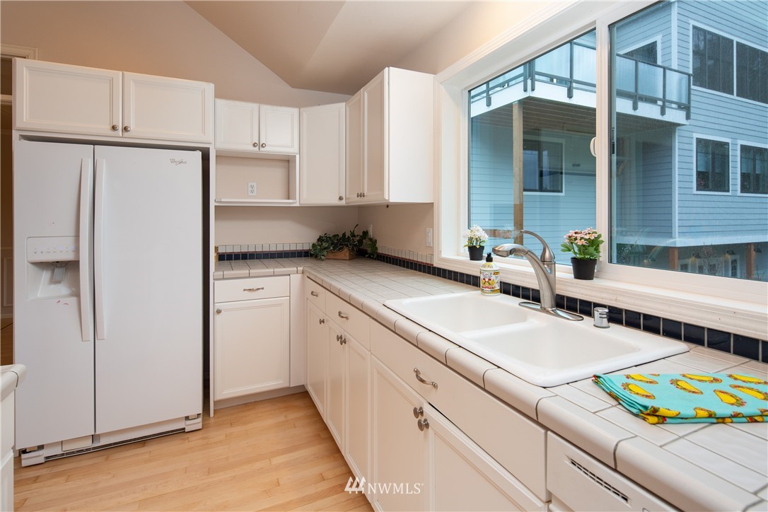 208 Sea Pines Road Bellingham, WA 98229 - Photo 19 of 34 a kitchen with stainless steel appliances a sink and a refrigerator
