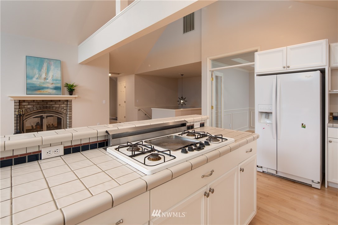 208 Sea Pines Road Bellingham, WA 98229 - Photo 20 of 34 a kitchen with stainless steel appliances granite countertop a stove a sink and a refrigerator