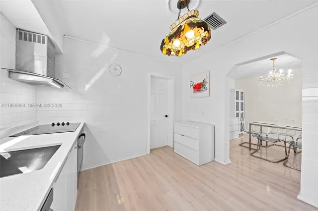 a kitchen with a sink stainless steel appliances and cabinets