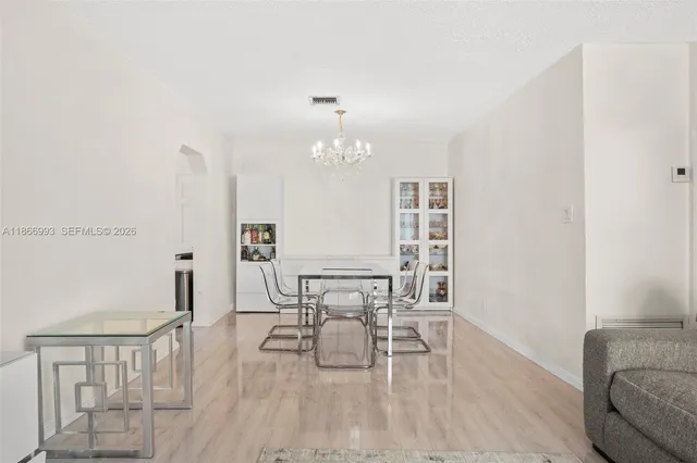 a view of a dining room with furniture and a flat screen tv