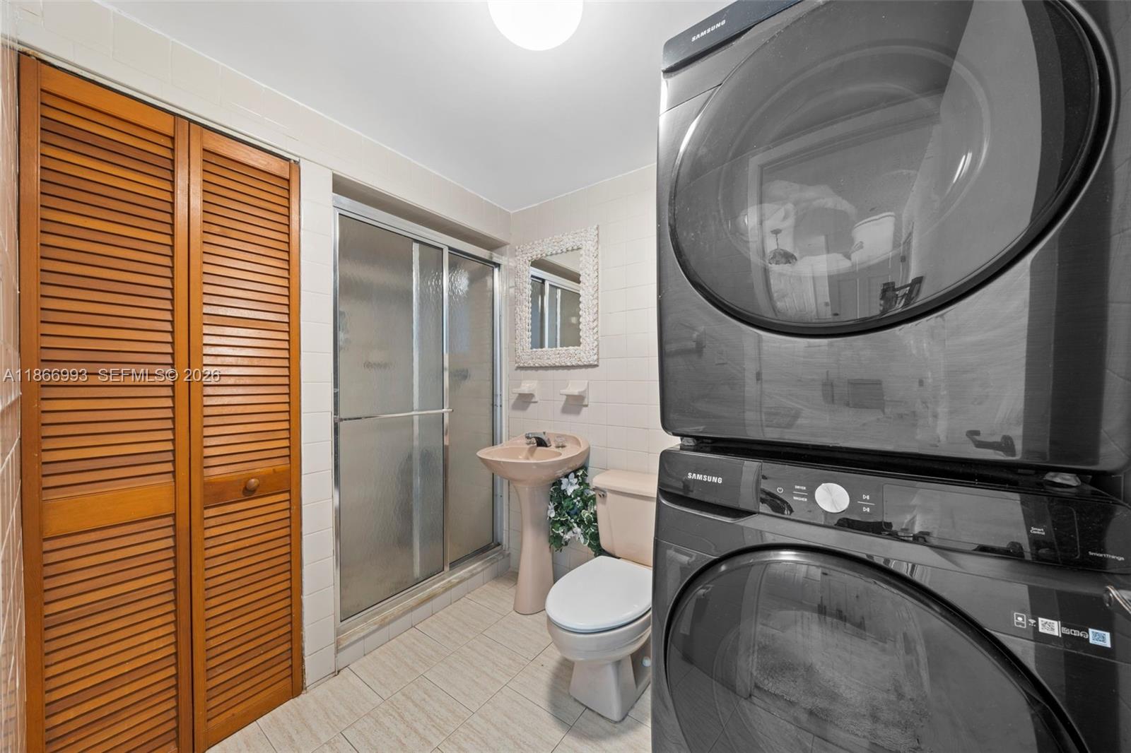 1935 Arthur Street Hollywood, FL 33020 - Photo 18 of 28 a bathroom with a granite countertop toilet sink and mirror