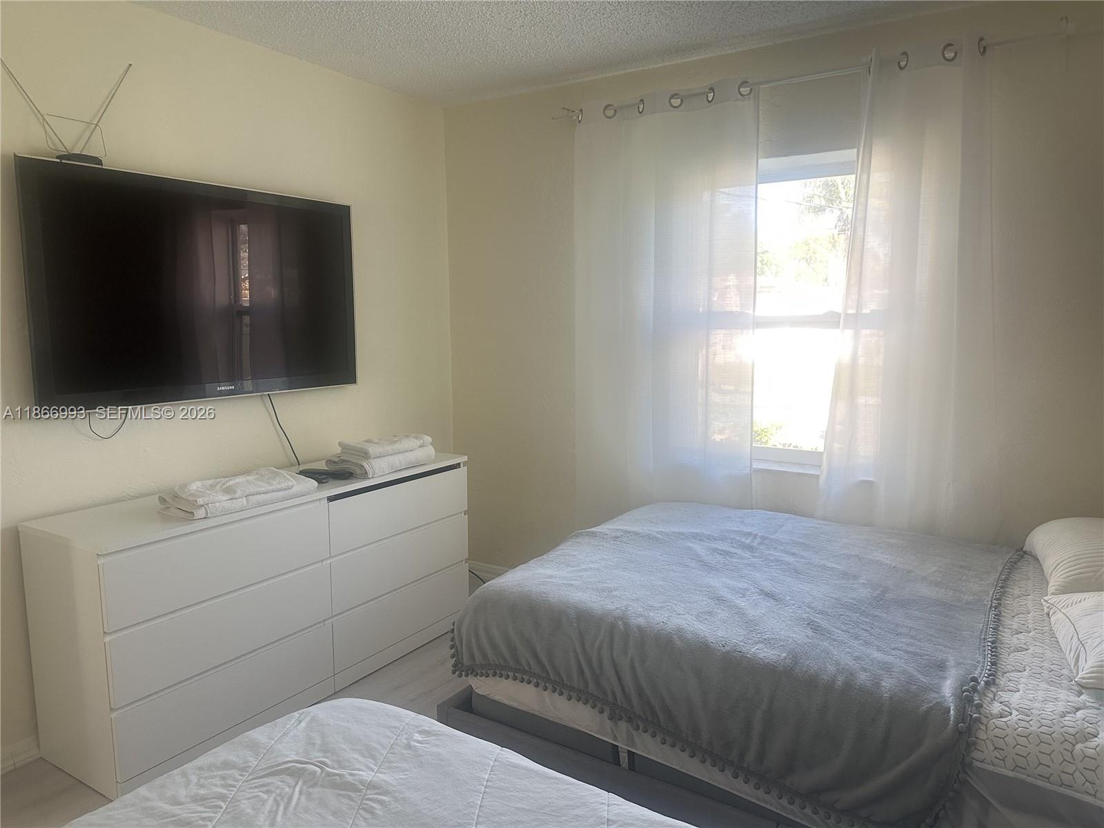 1935 Arthur Street Hollywood, FL 33020 - Photo 21 of 28 a bedroom with a bed and a flat screen tv