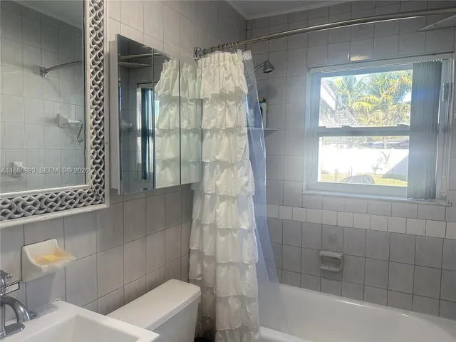 a living room with furniture and a toilet