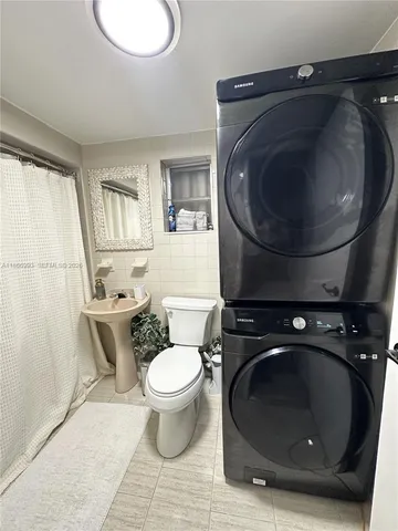 a bedroom with two beds and a flat screen tv