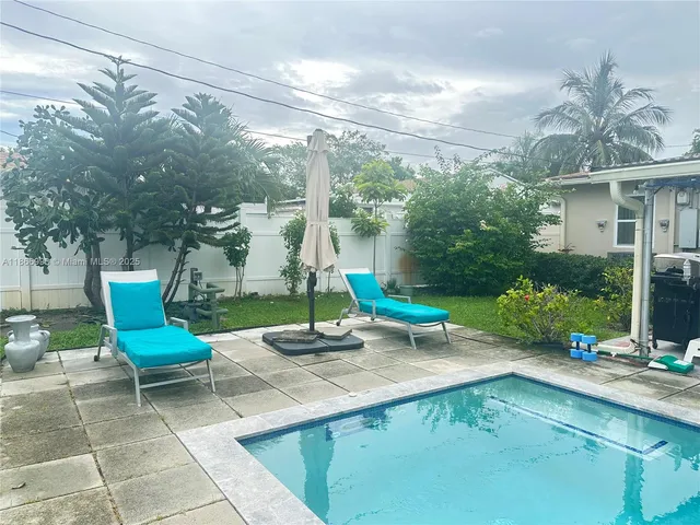 a building outdoor space with patio furniture and potted plants