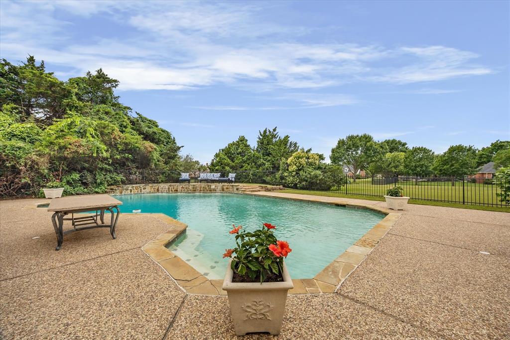 506 Meadowview Road Heath, TX 75032 - Photo 26 of 32 a view of a lake with table and chairs and potted plants