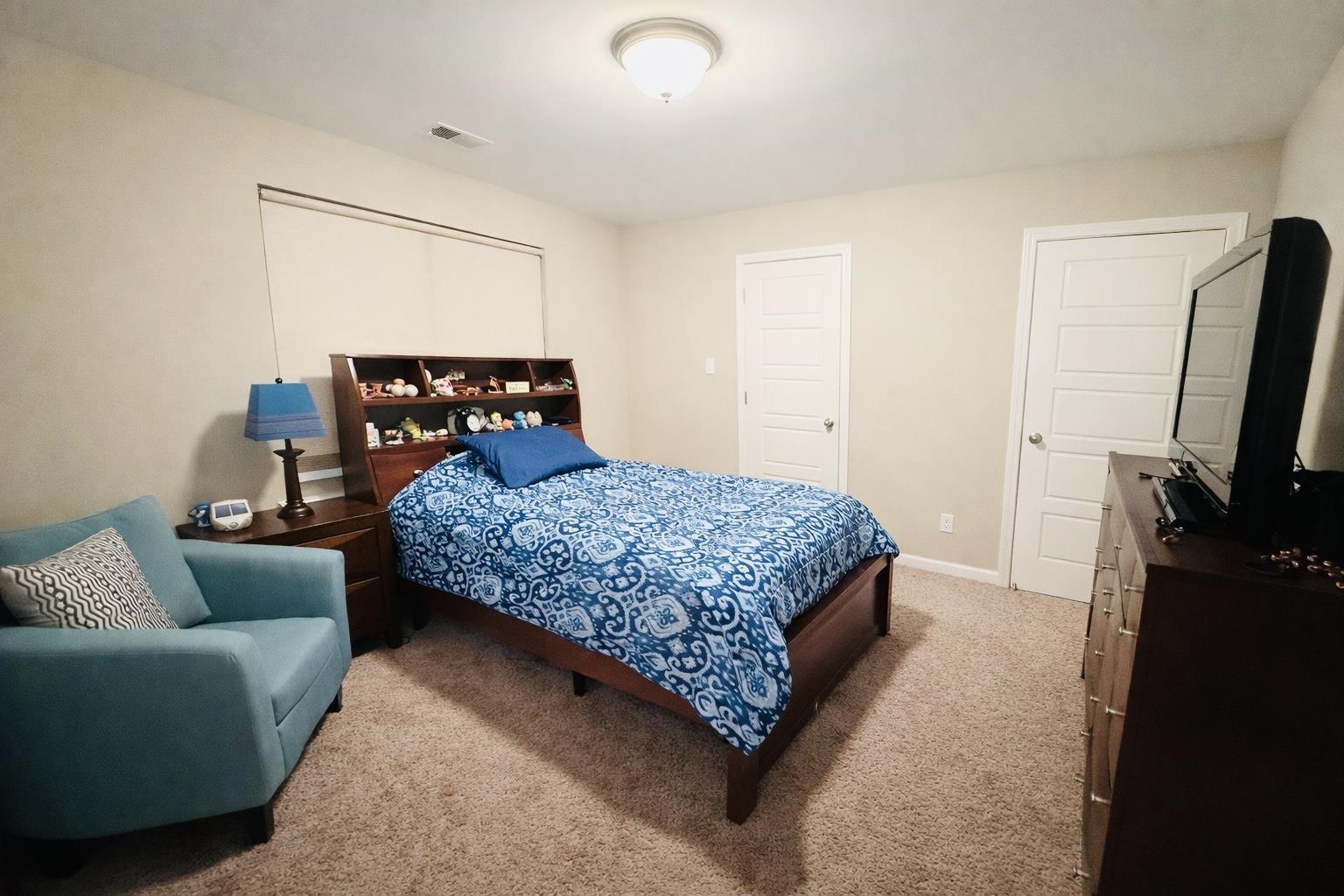 8443 Butterfly View Lane Bartlett, TN 38133 - Photo 7 of 12 a bedroom with a bed a couch and a flat tv screen on a dresser