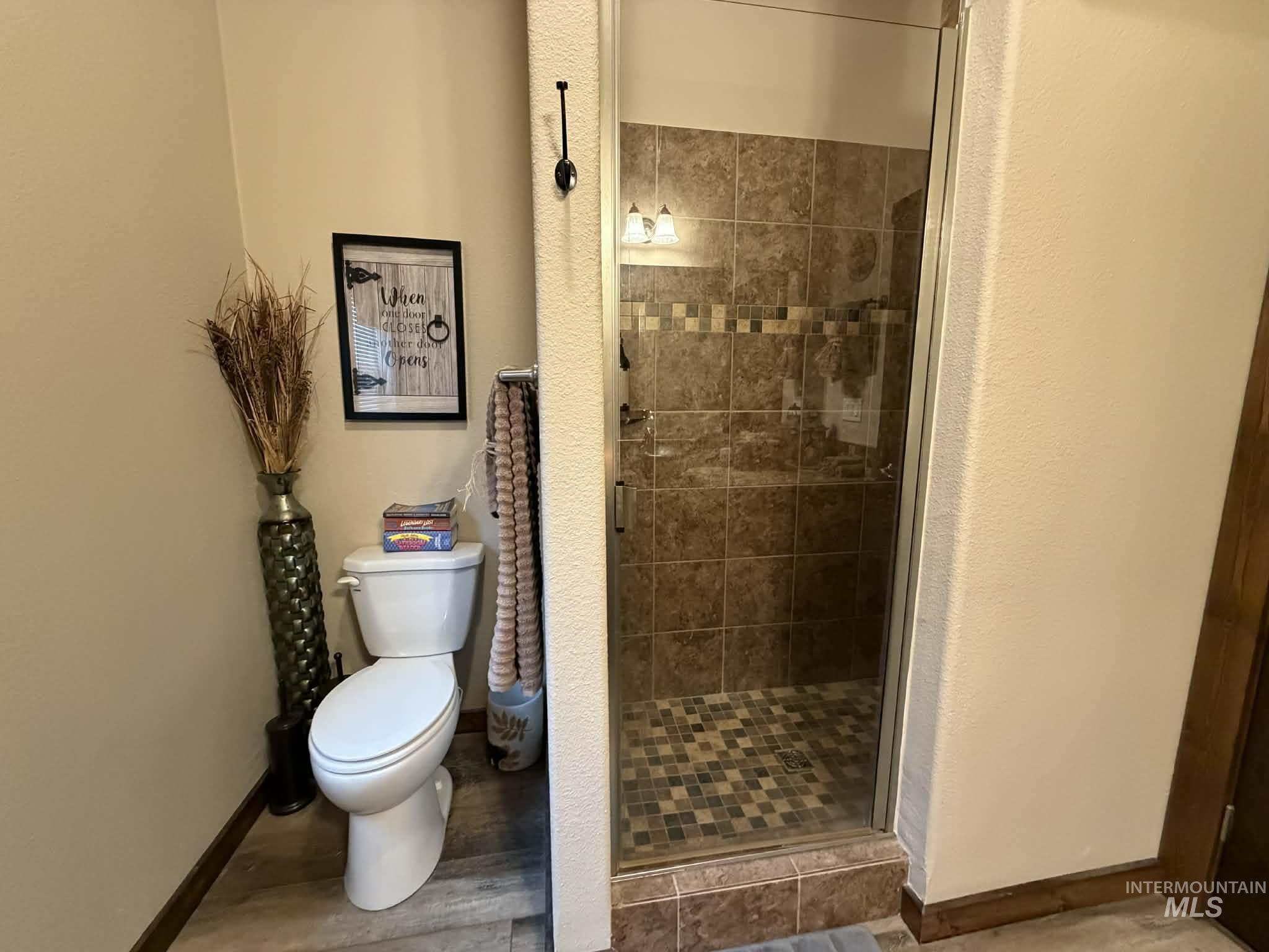 19378 Homestead Loop Lewiston, ID 83501 - Photo 22 of 42 Full bathroom with a stall shower and wood finished floors