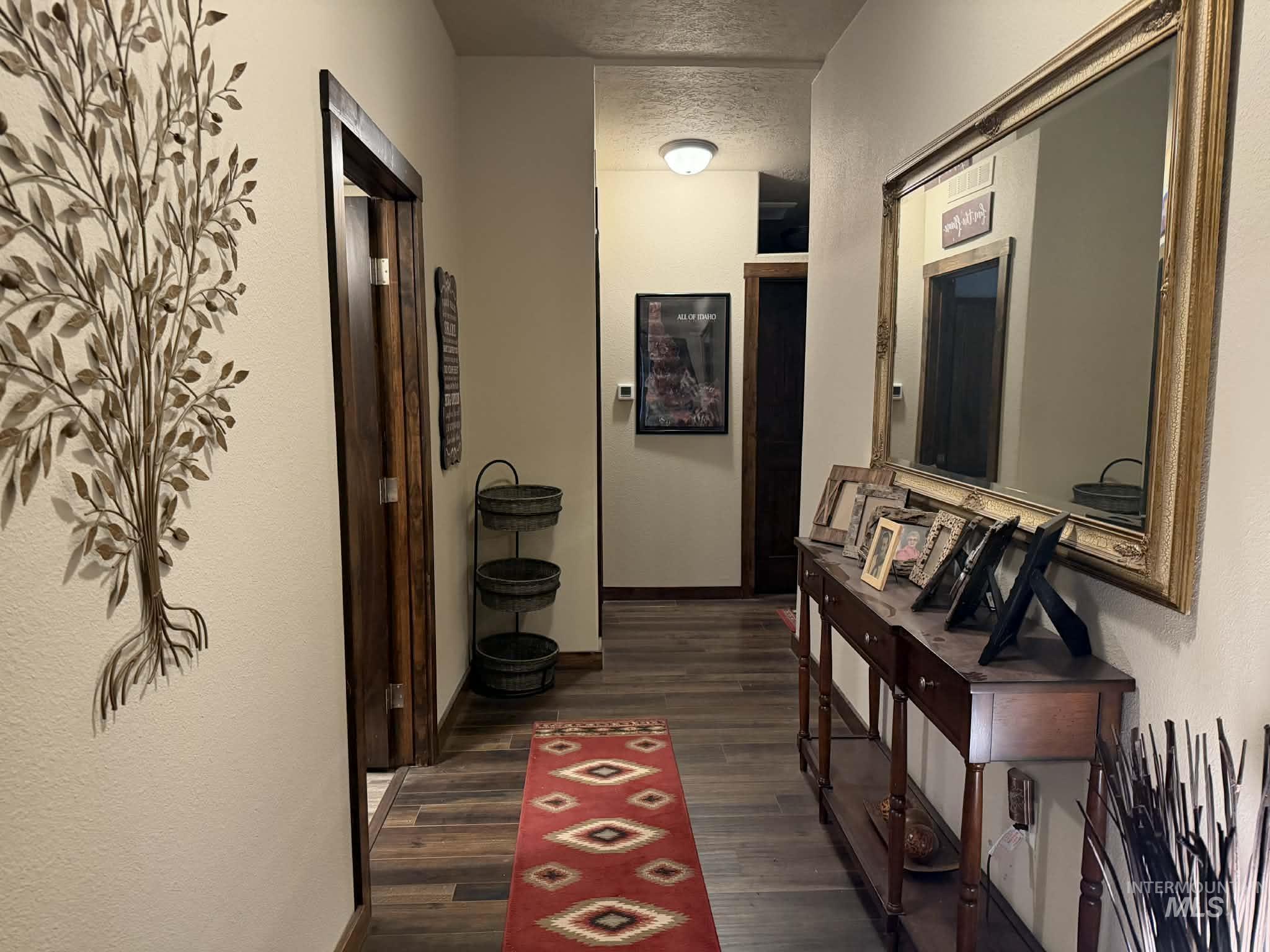 19378 Homestead Loop Lewiston, ID 83501 - Photo 23 of 42 Corridor with a textured wall and dark wood finished floors