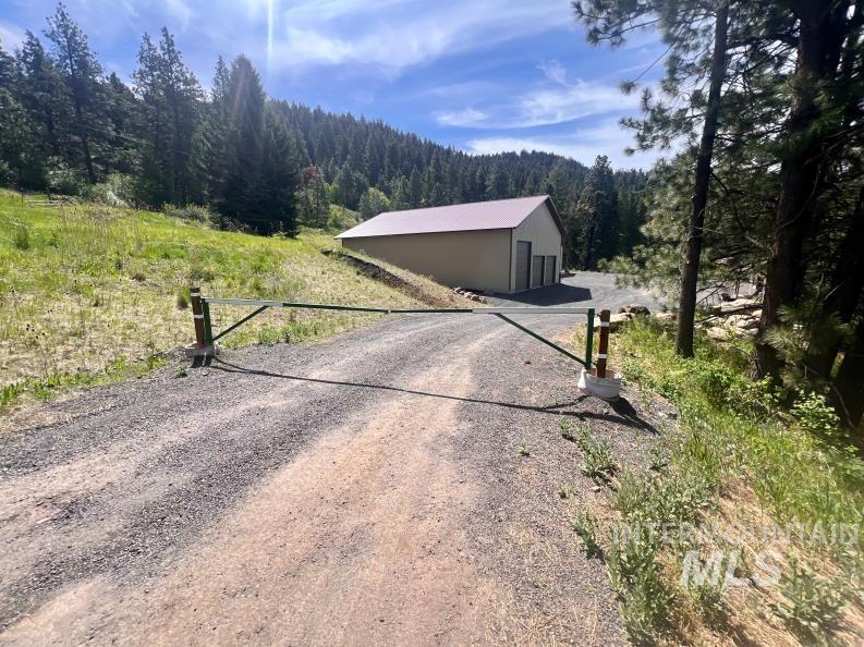 19378 Homestead Loop Lewiston, ID 83501 - Photo 26 of 42 View of home's exterior featuring a wooded view and an outbuilding