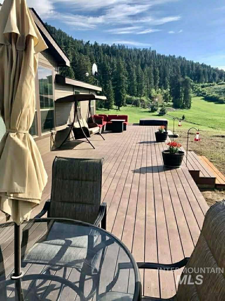 19378 Homestead Loop Lewiston, ID 83501 - Photo 29 of 42 Wooden terrace featuring outdoor dining area and a wooded view