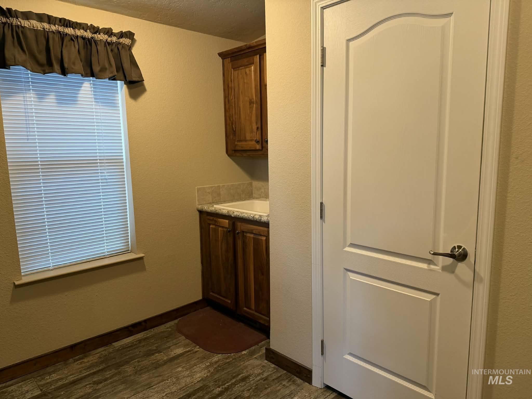 19378 Homestead Loop Lewiston, ID 83501 - Photo 35 of 42 Washroom with a textured wall, dark wood-style floors, and a textured ceiling