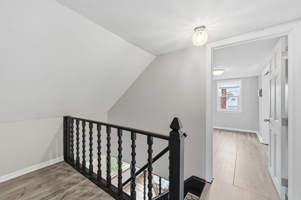 104 Chateaugay Street Chicopee, MA 01020 - Photo 27 of 38 a view of a hallway with wooden floor and staircase
