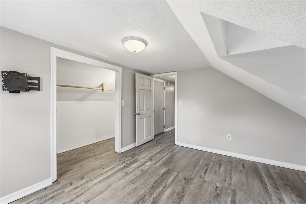 104 Chateaugay Street Chicopee, MA 01020 - Photo 29 of 38 a view of an empty room with wooden floor