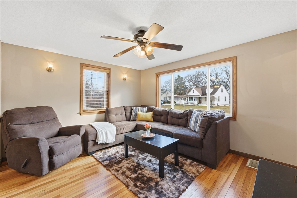 104 Chateaugay Street Chicopee, MA 01020 - Photo 8 of 38 a living room with furniture a chandelier and a window