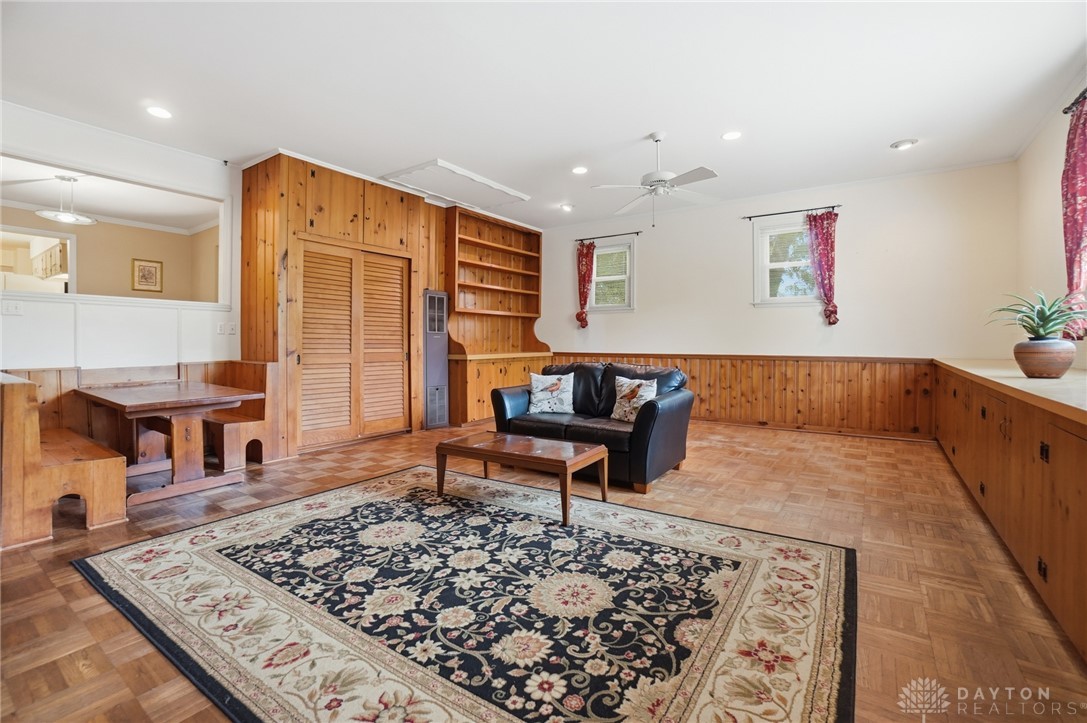 6119 Flemington Road Dayton, OH 45459 - Photo 20 of 76 This inviting living space features warm wood paneling and built-in shelving, perfect for comfortable gatherings.
