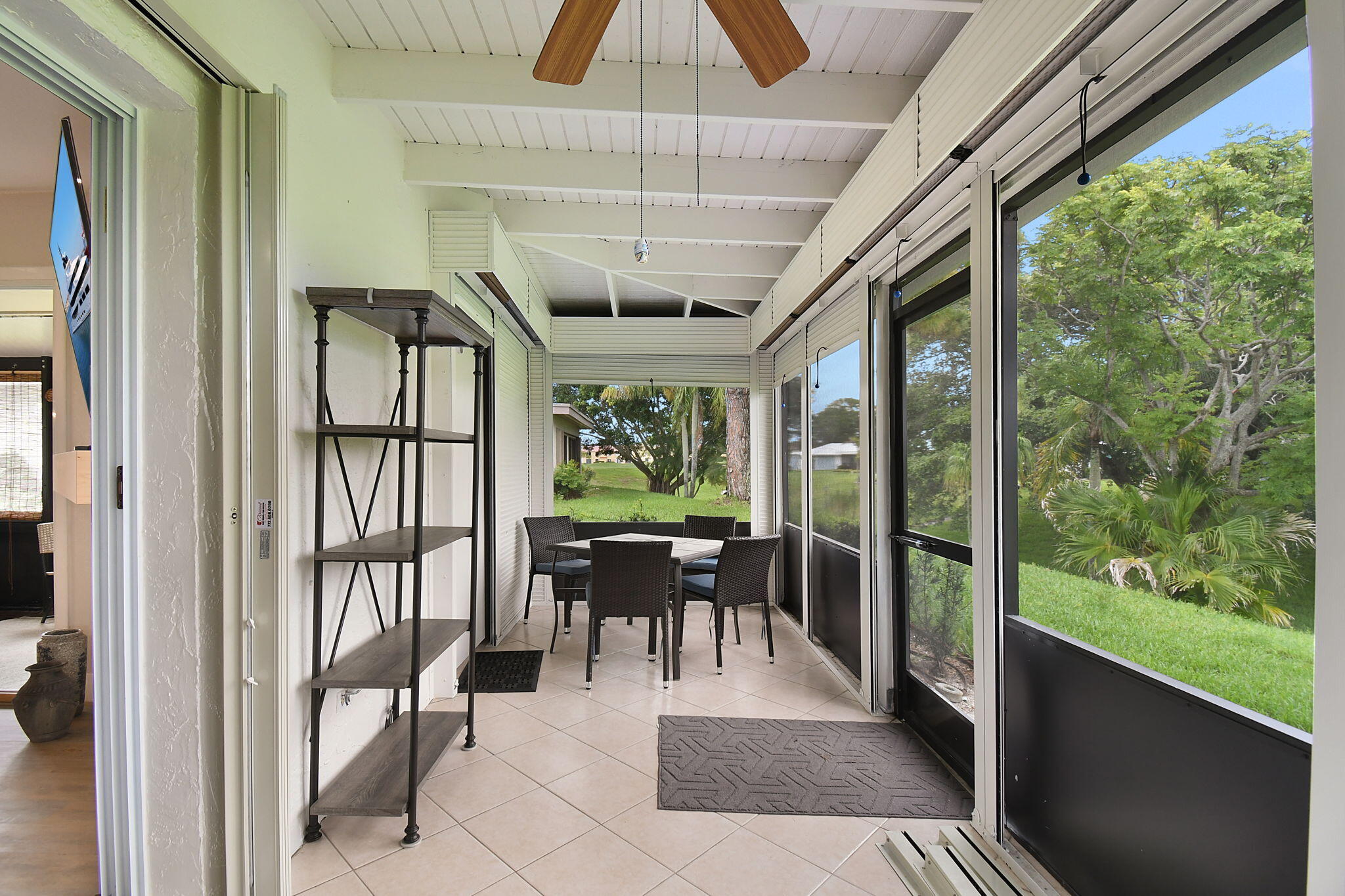 5251 Southeast Sea Island Way Stuart, FL 34997 - Photo 31 of 68 a view of a porch with chairs and backyard