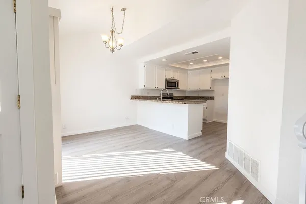 a kitchen with stainless steel appliances granite countertop a sink and a stove