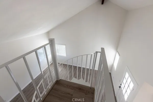 a view of staircase with white walls and a window