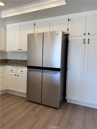 a white refrigerator freezer sitting in a kitchen