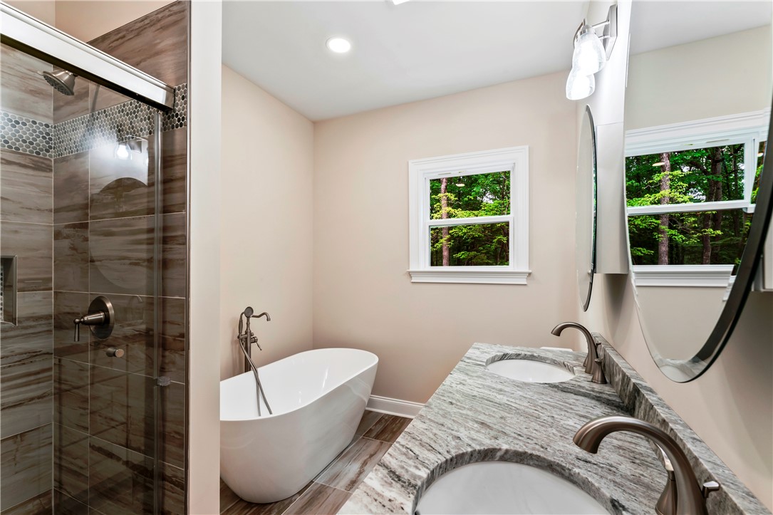 110 Gabriel Way Pickens, SC 29671 - Photo 20 of 48 A well-appointed bathroom features a freestanding soaking tub and dual vanity with sleek fixtures.