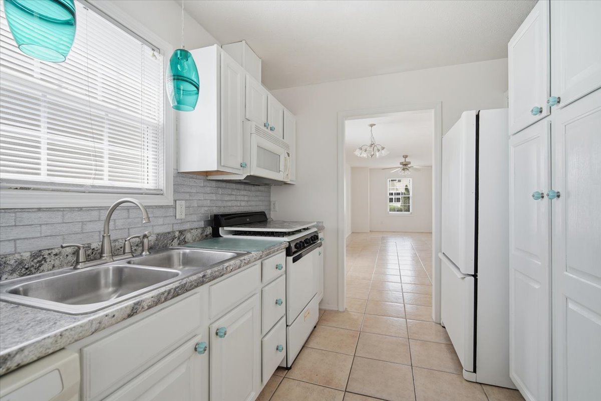915 Teegan Street Normal, IL 61761 - Photo 10 of 33 a kitchen with stainless steel appliances granite countertop a sink and a refrigerator