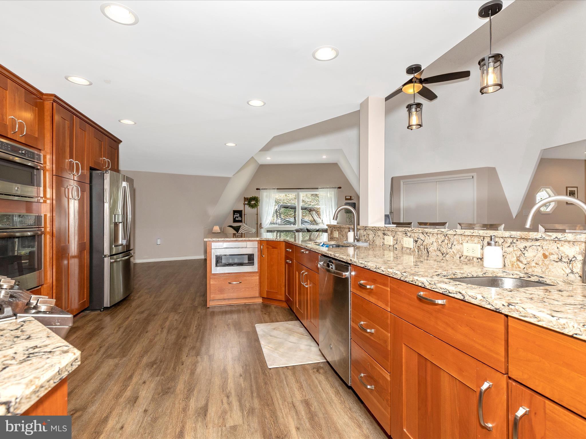 111 Bachmans Valley Road Westminster, MD 21158 - Photo 23 of 97 a large kitchen with stainless steel appliances kitchen island granite countertop a large counter top and sink