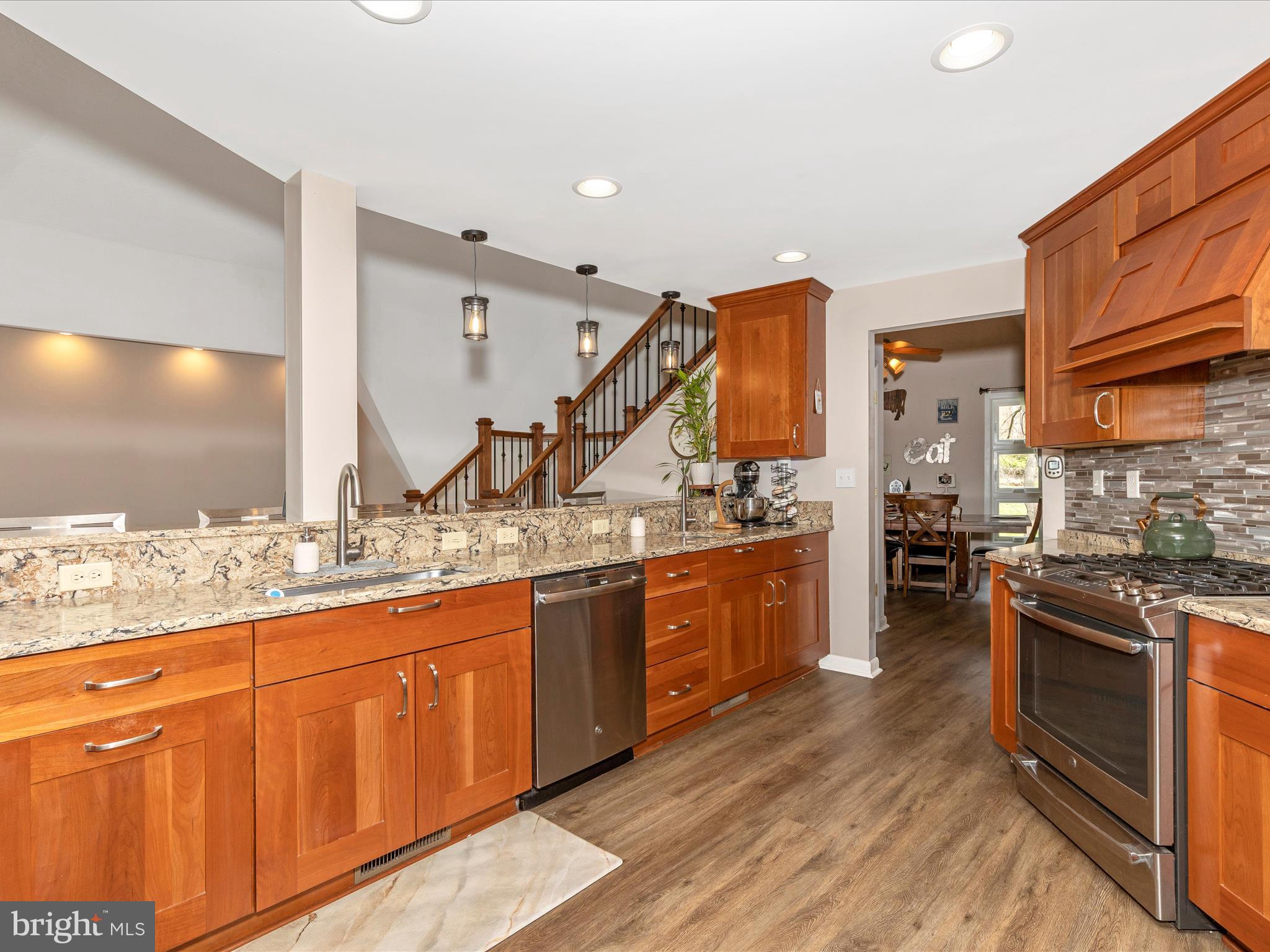 111 Bachmans Valley Road Westminster, MD 21158 - Photo 24 of 97 a kitchen with stainless steel appliances granite countertop a sink and wooden cabinets