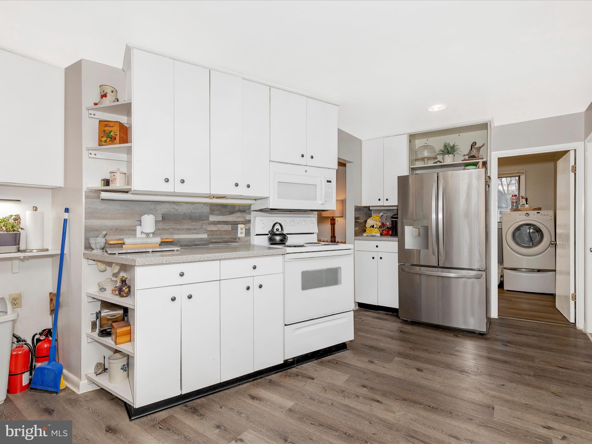 111 Bachmans Valley Road Westminster, MD 21158 - Photo 40 of 97 a kitchen with granite countertop white cabinets and refrigerator