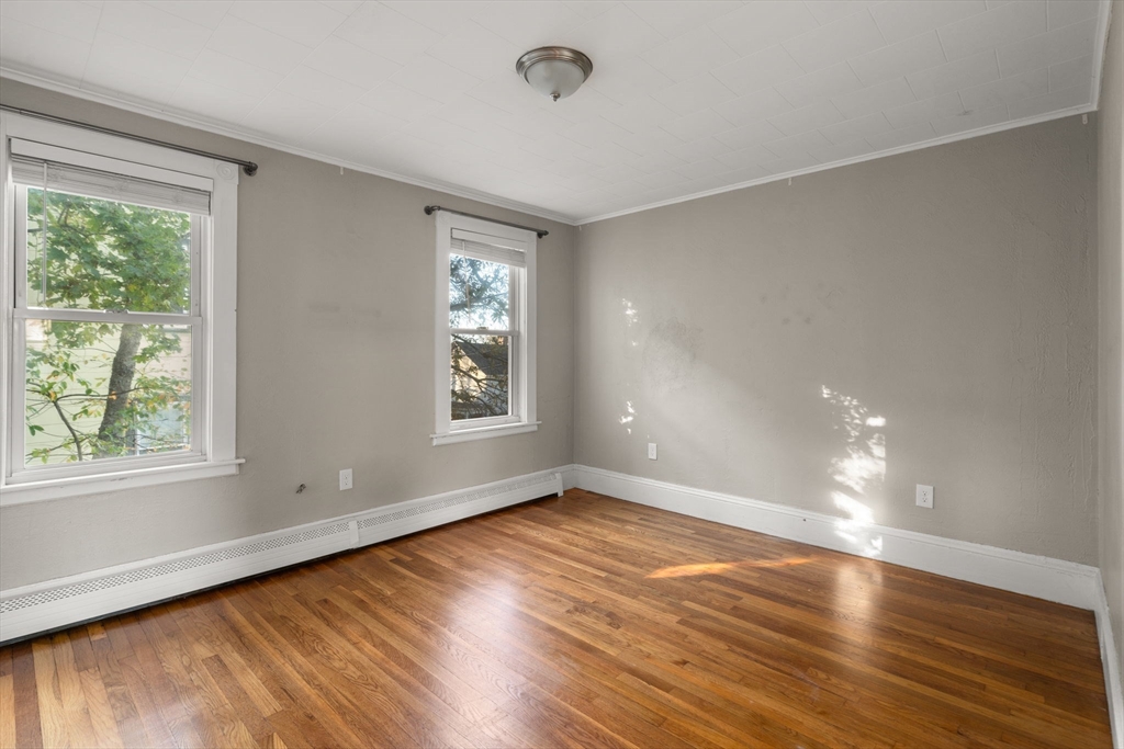 55 Butler Street Salem, MA 01970 - Photo 11 of 31 an empty room with wooden floor and windows
