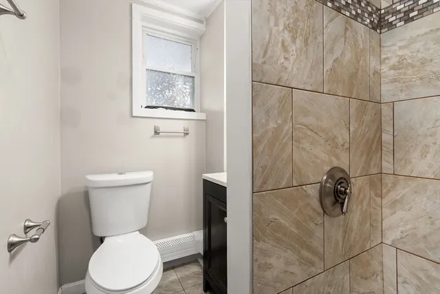 a white toilet sitting next to a bathroom sink