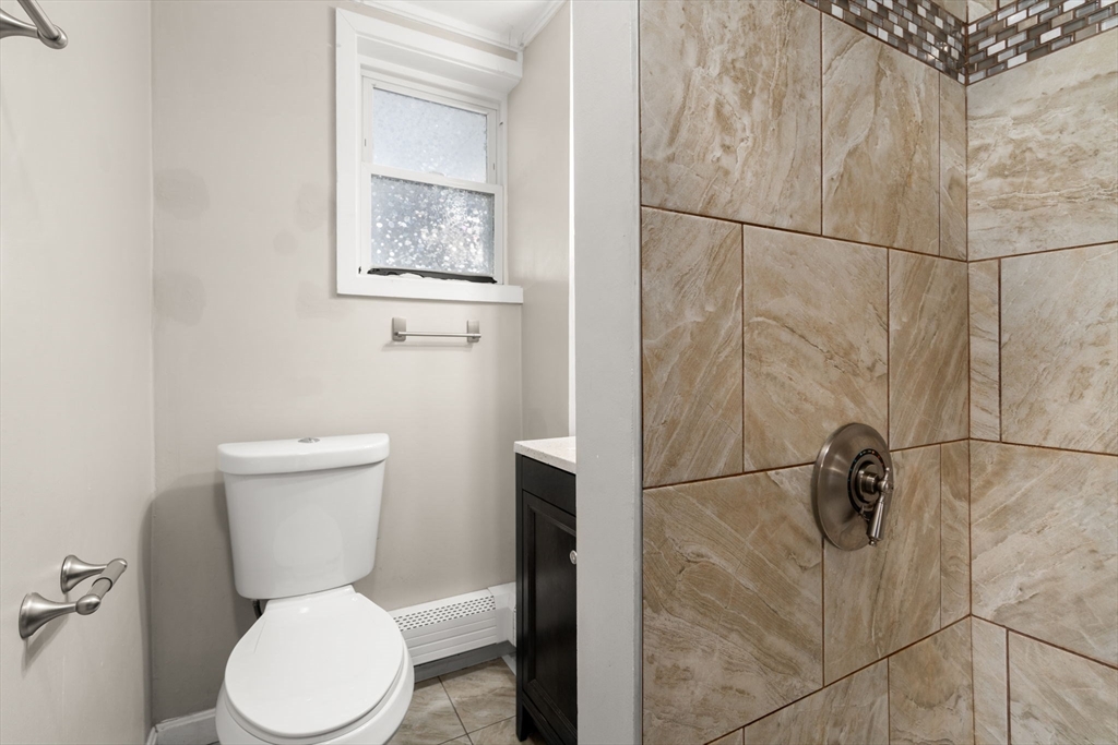 55 Butler Street Salem, MA 01970 - Photo 14 of 31 a white toilet sitting next to a bathroom sink