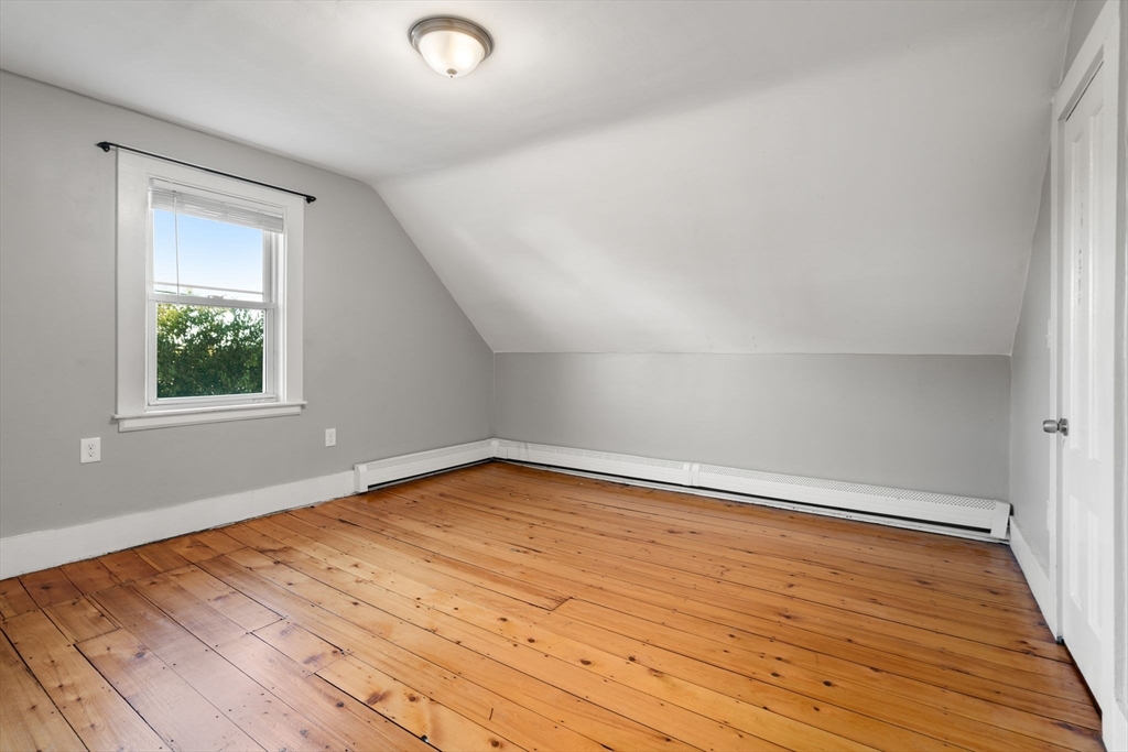 55 Butler Street Salem, MA 01970 - Photo 18 of 31 an empty room with wooden floor and windows