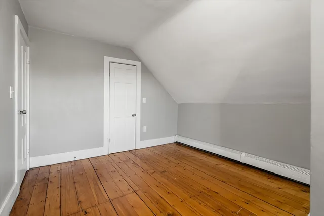 a kitchen with stainless steel appliances granite countertop a stove top oven a sink dishwasher a refrigerator and a dining table with wooden floor