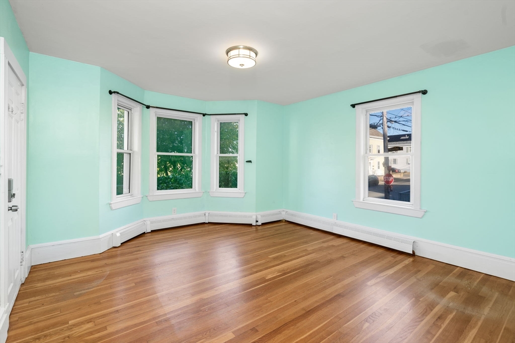 55 Butler Street Salem, MA 01970 - Photo 24 of 31 a view of an empty room with wooden floor and a window