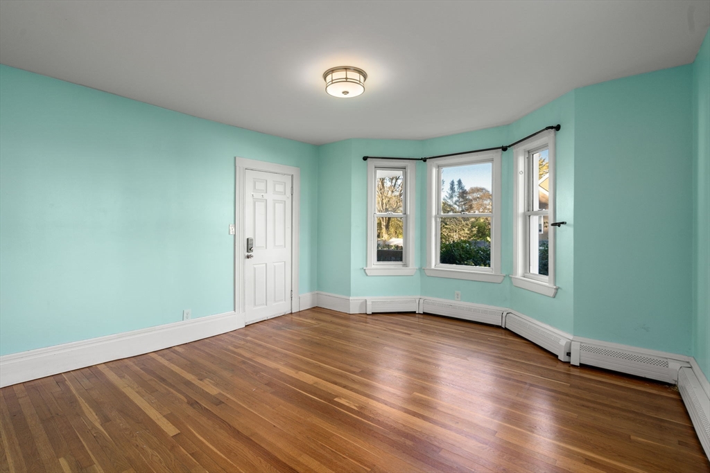 55 Butler Street Salem, MA 01970 - Photo 25 of 31 a view of an empty room with wooden floor and a window