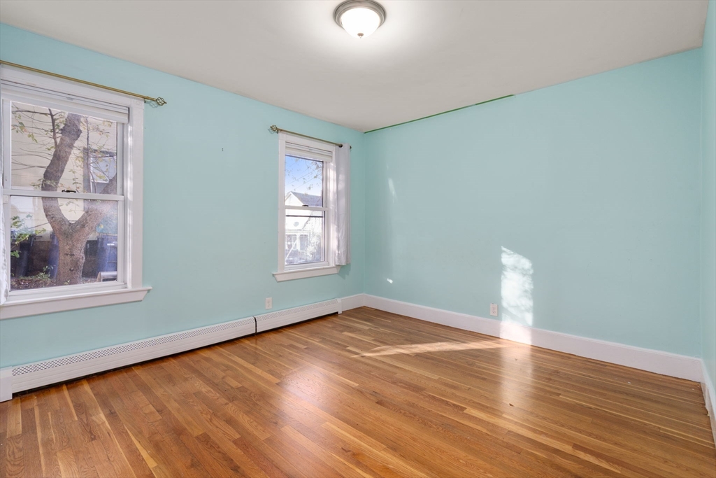 55 Butler Street Salem, MA 01970 - Photo 27 of 31 an empty room with wooden floor and windows