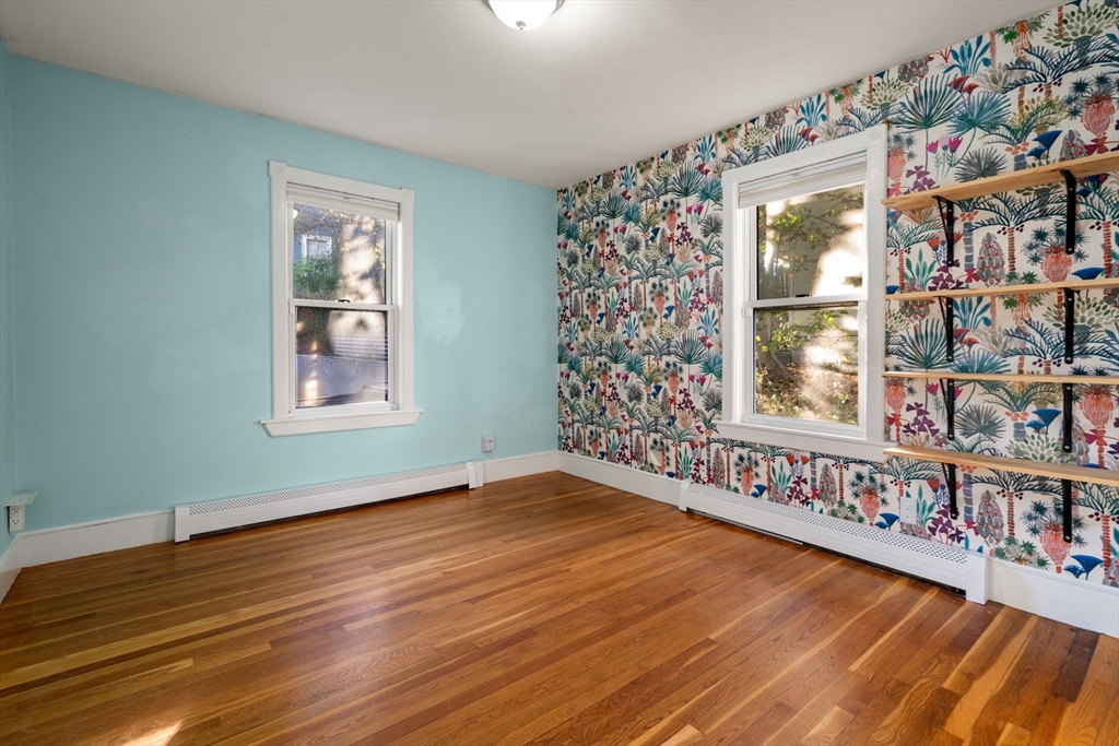 55 Butler Street Salem, MA 01970 - Photo 28 of 31 a view of an empty room with window and wooden floor