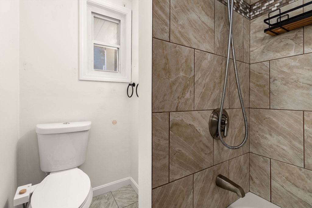 55 Butler Street Salem, MA 01970 - Photo 29 of 31 a white toilet sitting next to a bathroom sink