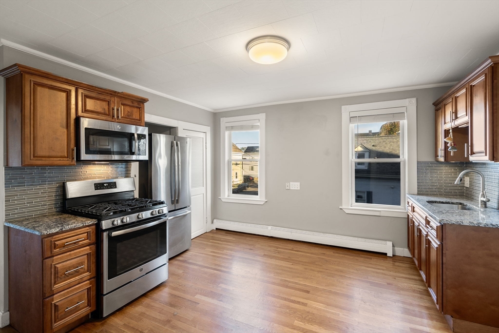 55 Butler Street Salem, MA 01970 - Photo 6 of 31 a kitchen with stainless steel appliances granite countertop a stove a sink and a microwave