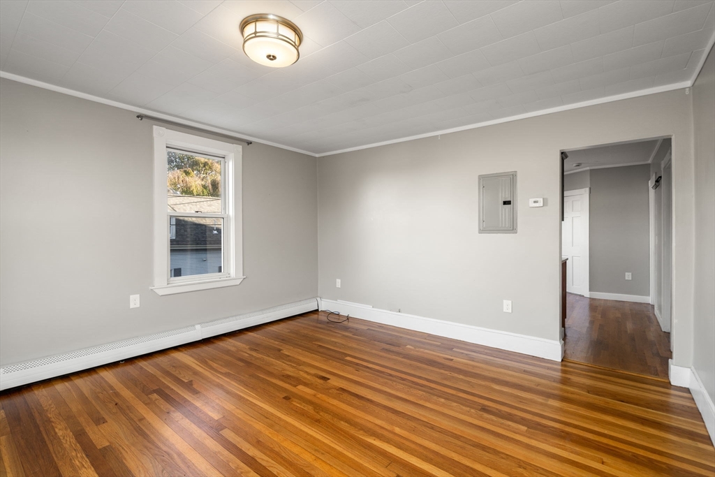 55 Butler Street Salem, MA 01970 - Photo 10 of 31 a view of an empty room with wooden floor and a window