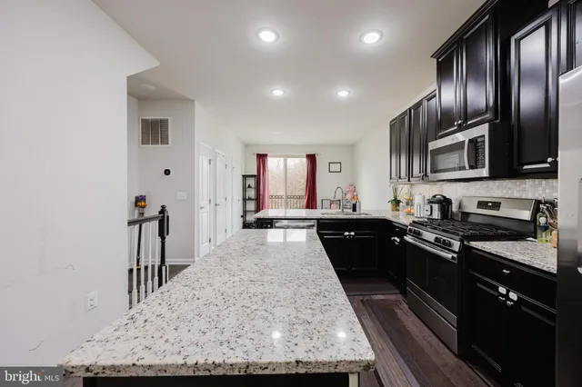a large kitchen with granite countertop lots of counter top space