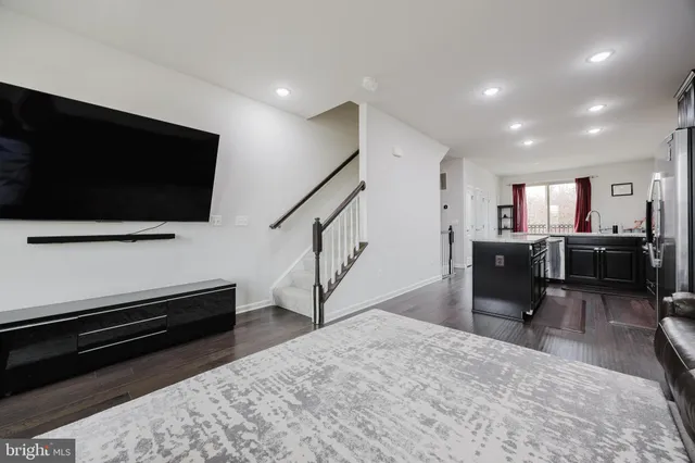 a view of a livingroom with furniture and a flat screen tv