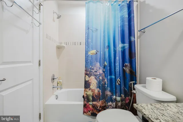 a bathroom with a toilet a sink and bathtub