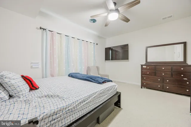 a bedroom with a bed and a dresser