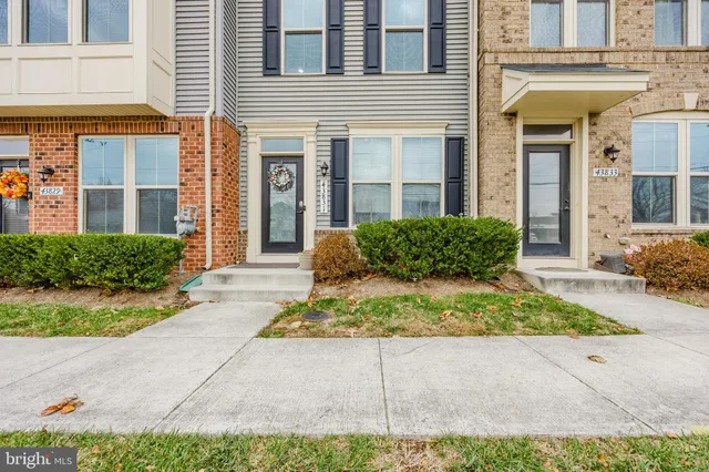 front view of a brick house with a small yard
