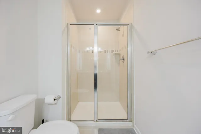 a bathroom with a shower a toilet and a sink