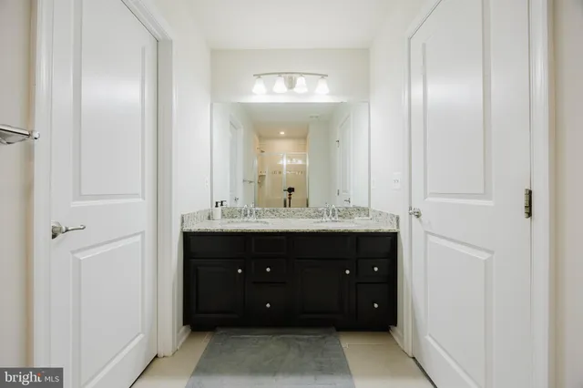 a bathroom with a sink vanity and a mirror